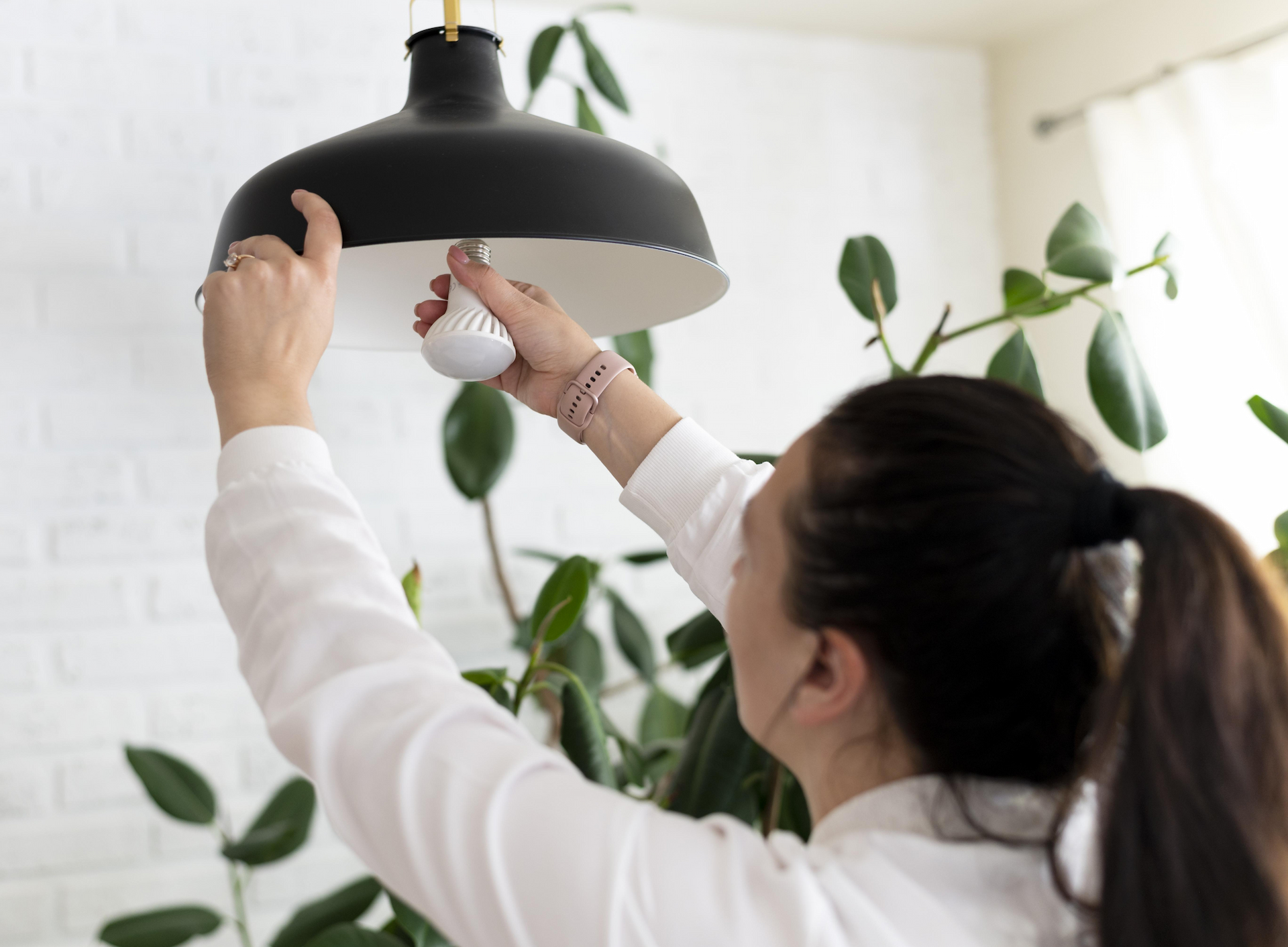 close-up-woman-changing-lightbulb.jpg